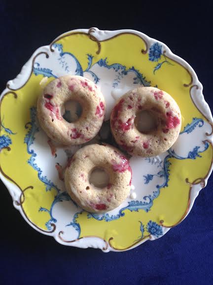 vanilla bean-raspberry baked doughnuts with orange glaze