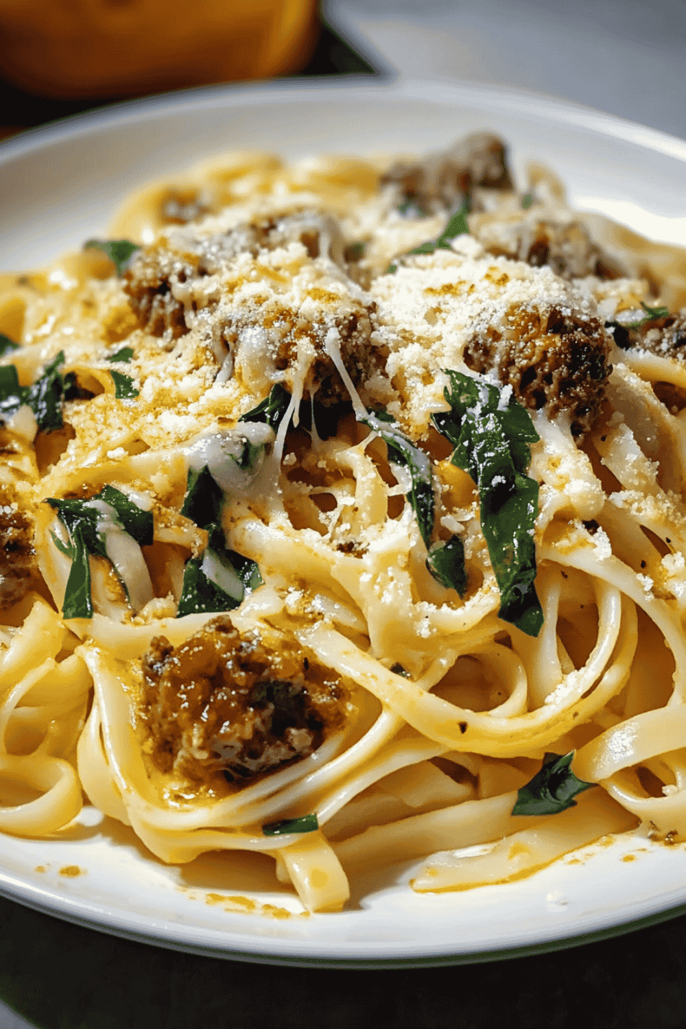 Skillet of linguine coated in creamy cheese sauce