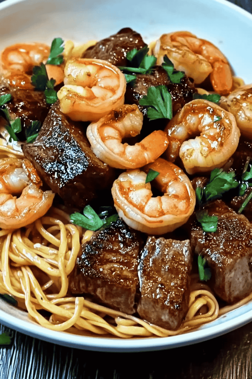Stir-fried surf and turf noodles in soy-based sauce