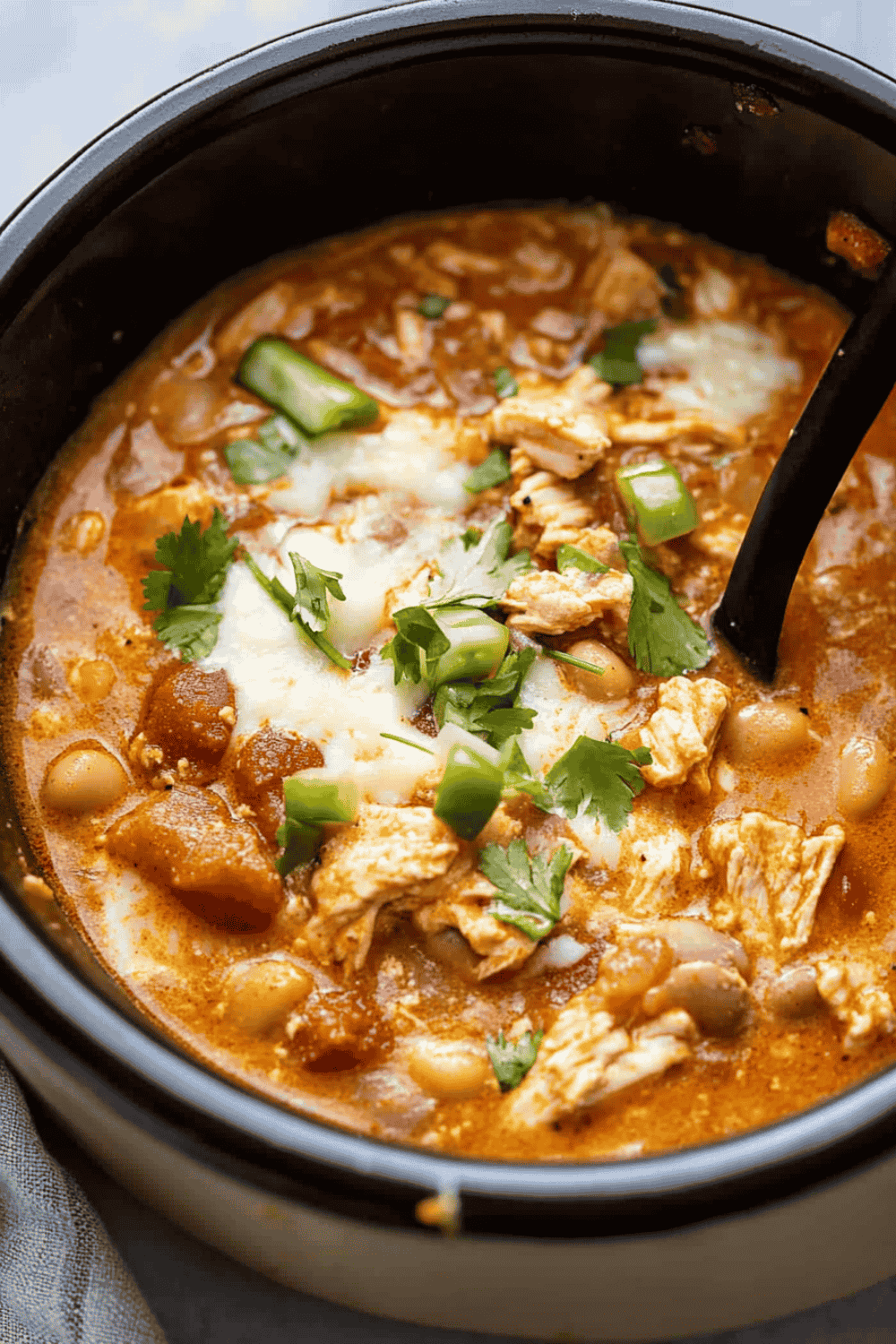 Creamy chili with spoon and tortilla chips