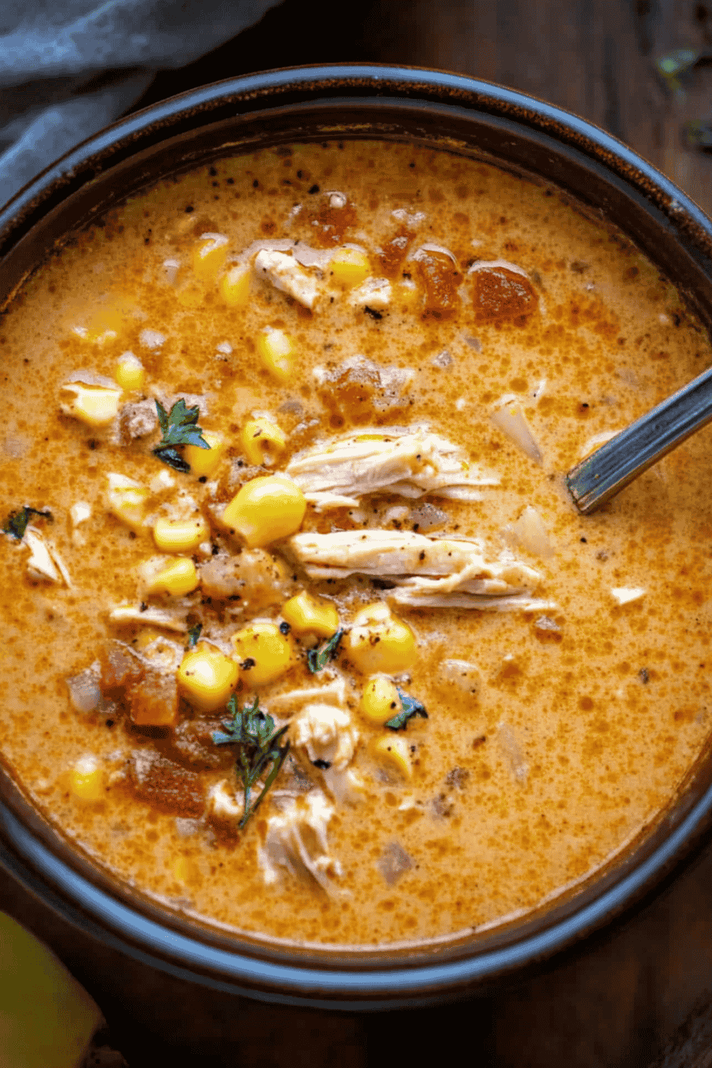 Creamy chicken soup topped with sour cream and avocado