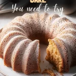 Glazed apple cider donut cake on rustic wooden board.