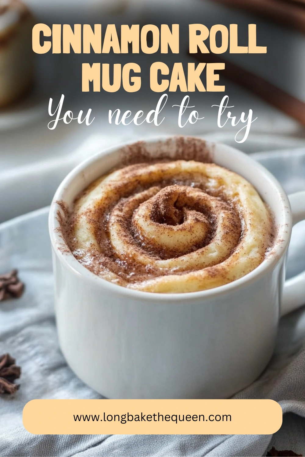 Warm cinnamon roll mug cake topped with glaze in white mug