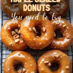 Freshly made maple glazed donuts on cooling rack