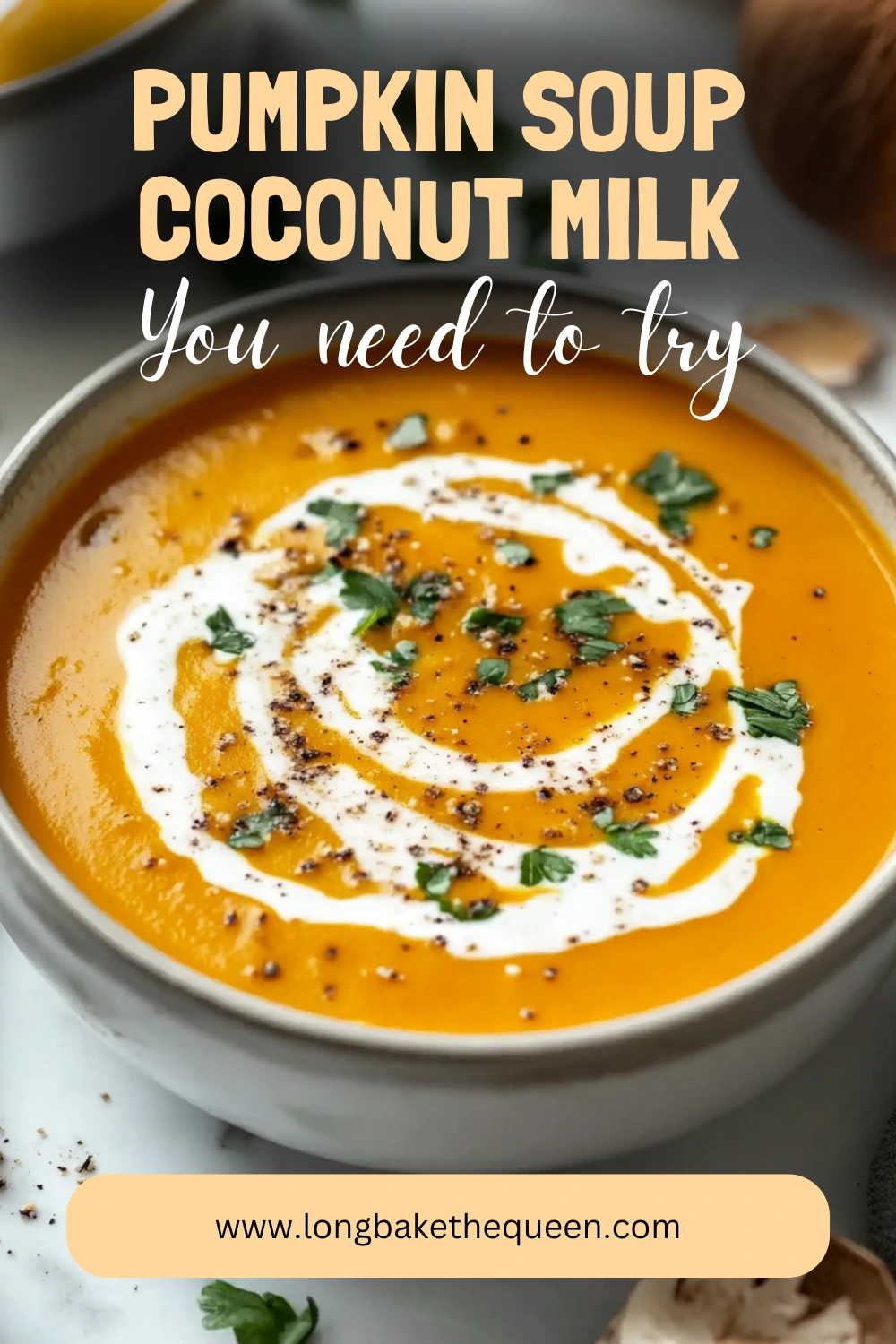 A steaming bowl of pumpkin soup coconut milk garnished with seeds and herbs.