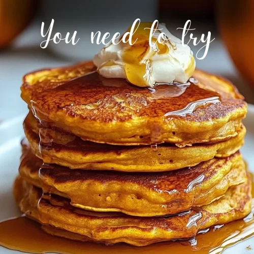 Fluffy golden stack of pumpkin pancakes with syrup drizzle