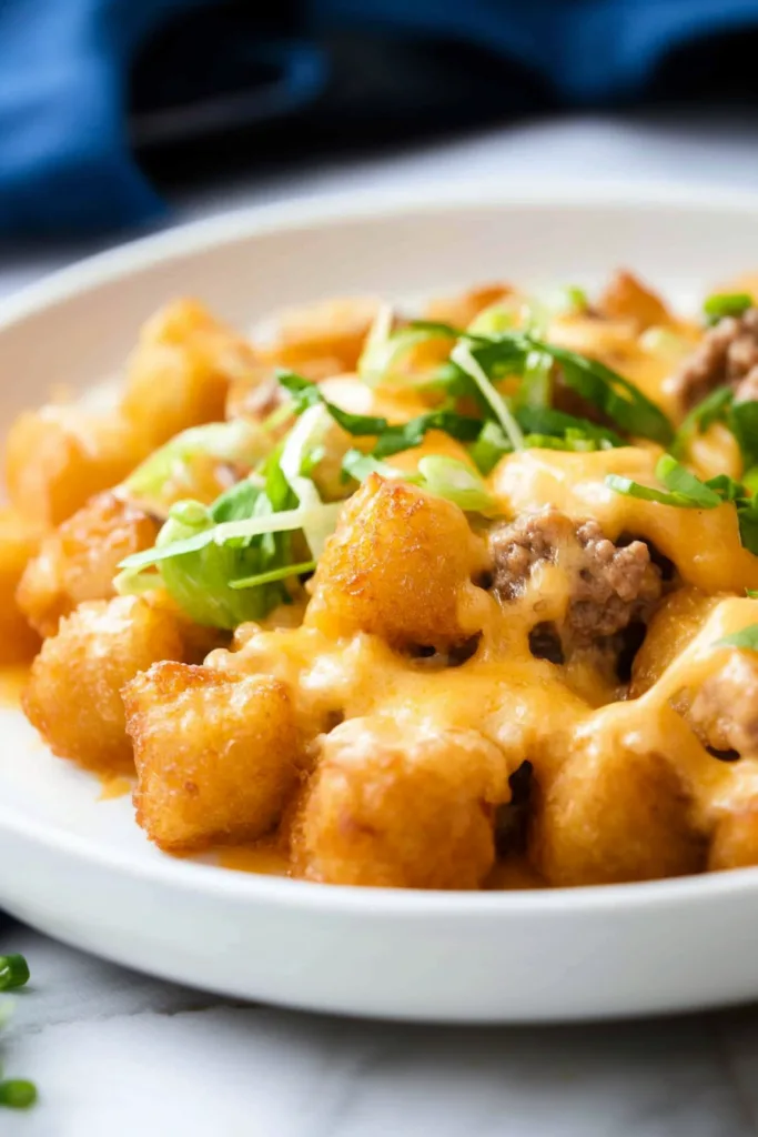 Final plated shot of a loaded tater tot bake with savory beef filling.