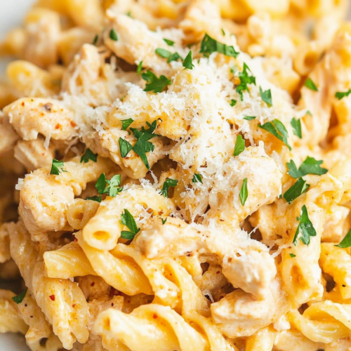 Hearty bowl of garlic Parmesan chicken pasta with cheesy, creamy texture.