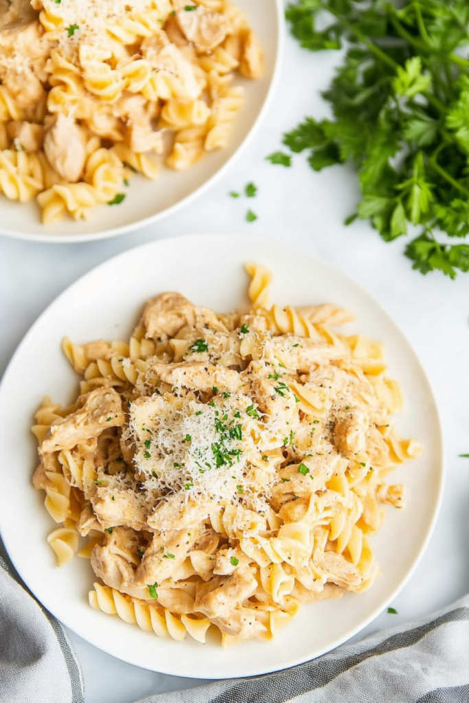 Slow-cooked chicken pasta in a creamy garlic Parmesan sauce, ready to serve.