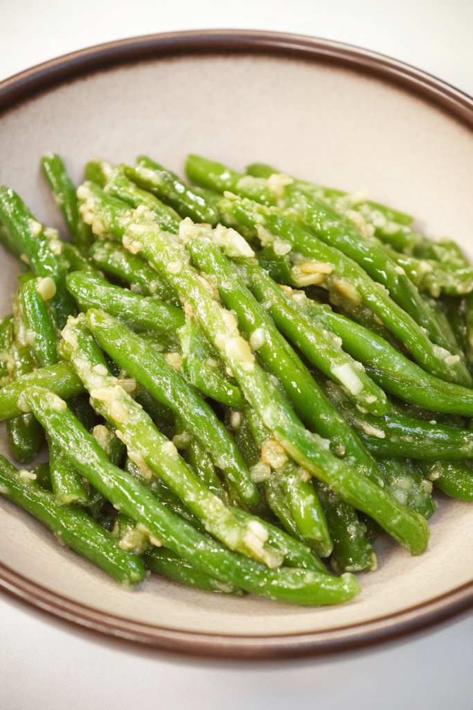 Crisp green beans tossed with garlic and a light savory coating.