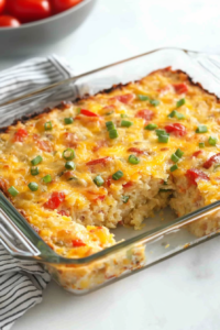 Freshly baked casserole with a crisp golden top and colorful vegetables mixed throughout.