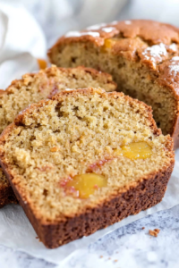 Close-up of sliced bread showing its soft, moist texture and speckled fruit inside.