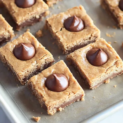 Close-up of soft dessert bars with chocolate pieces baked into the top.