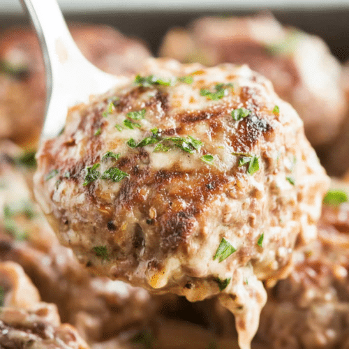 Tender beef patties simmered in rich brown gravy, garnished with fresh parsley.
