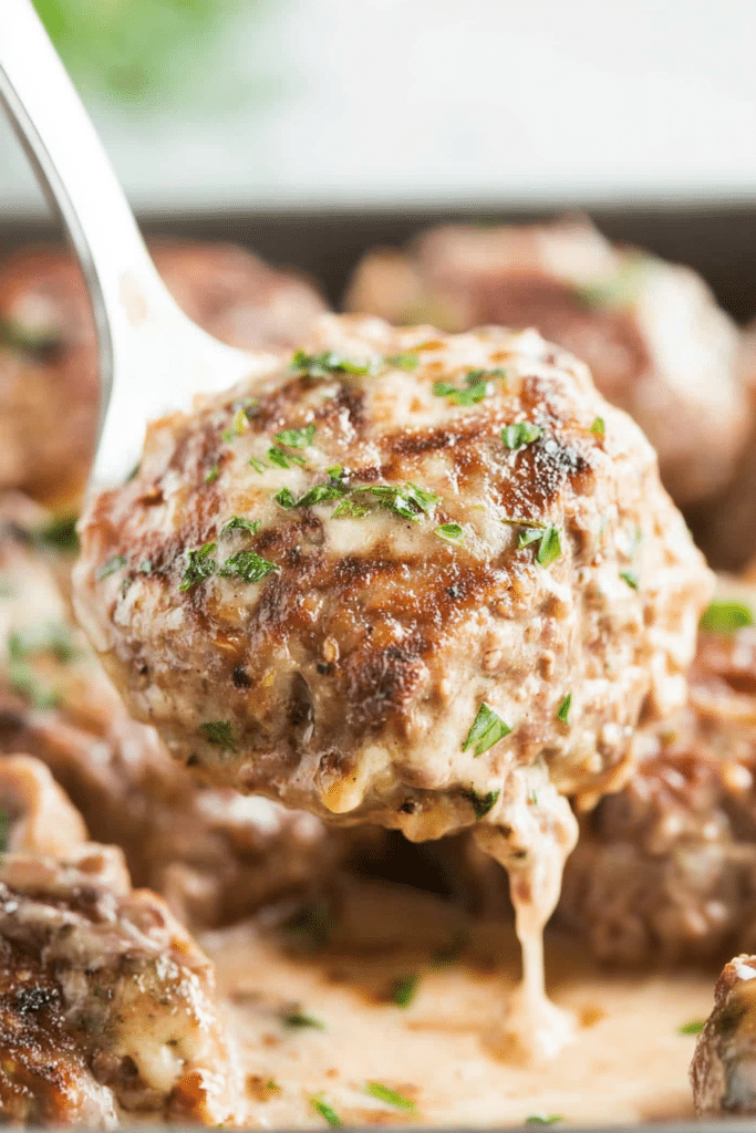 Tender beef patties simmered in rich brown gravy, garnished with fresh parsley.