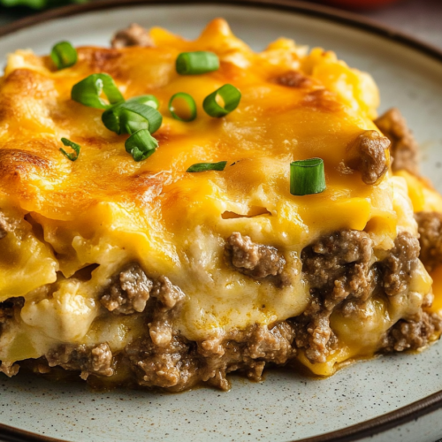 Cheesy beef casserole served on a plate with golden baked topping.