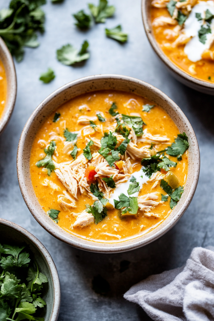 Hearty chicken chili with a creamy broth and fresh herb garnish.