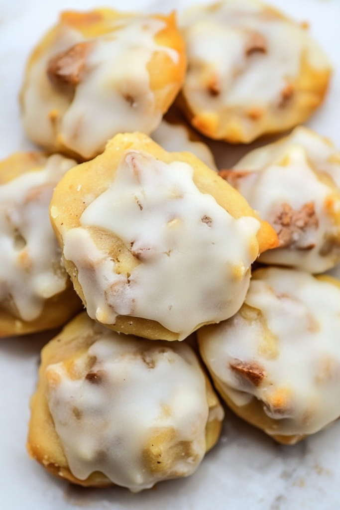 Stack of small homemade cookies with a glossy icing finish and tender crumb