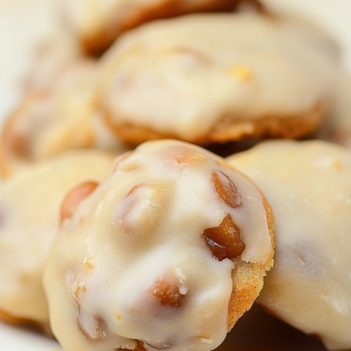 Glazed cookie bites with a soft, golden center and slightly crisp edges on a white plate