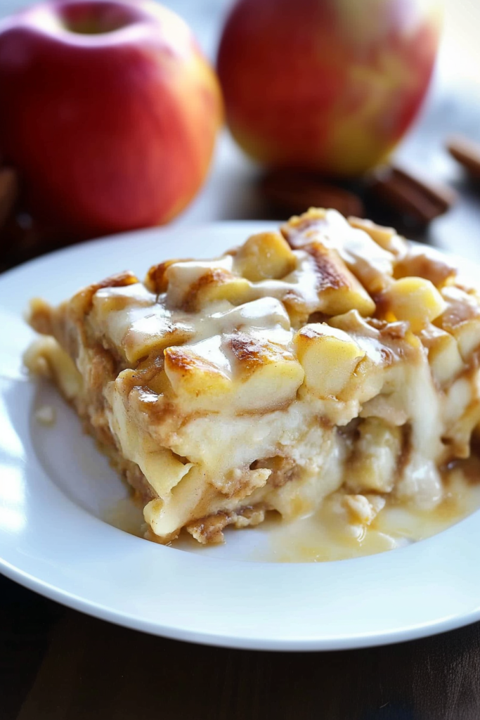Final presentation of Caramel Apple Cinnamon Roll Lasagna garnished with extra caramel sauce and fresh apple slices