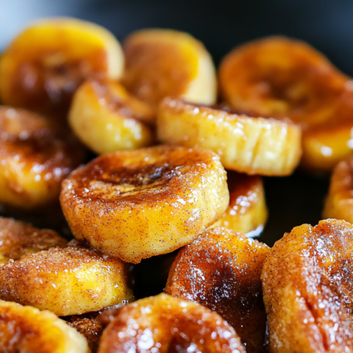 Warm cinnamon-dusted banana rounds served fresh from the pan