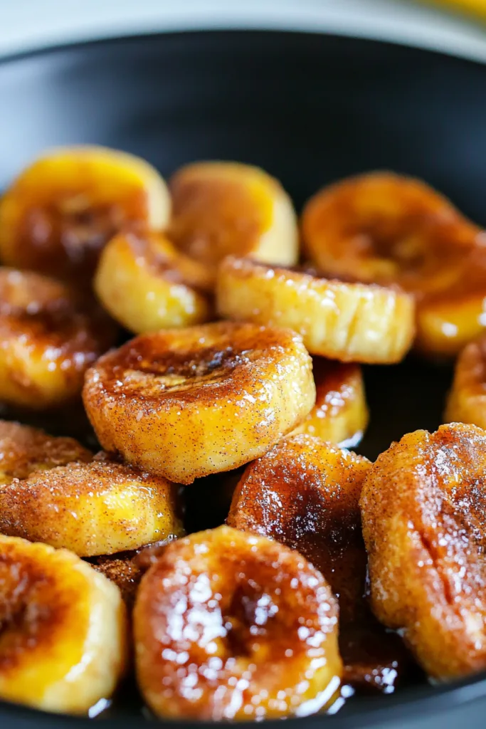 Warm cinnamon-dusted banana rounds served fresh from the pan