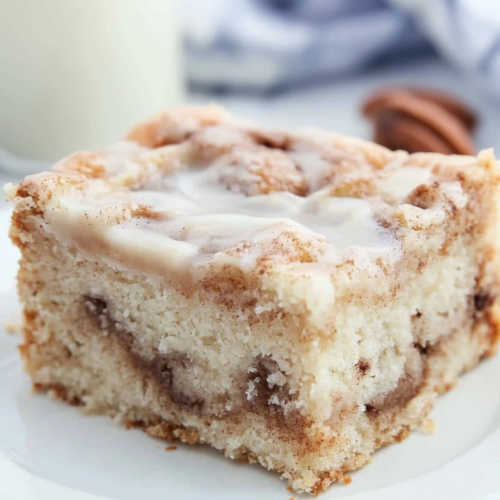 Coffee cake portion showing tender crumb and visible cinnamon ribbons