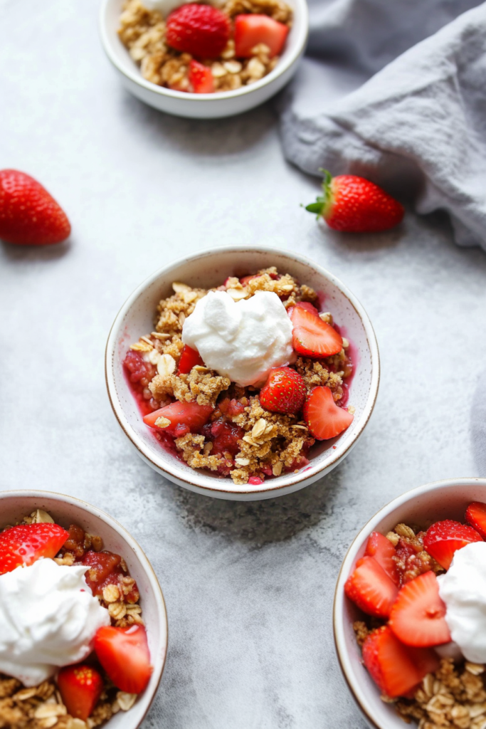 Homemade fruit crisp with fresh strawberries and crumbly topping in a ceramic bowl