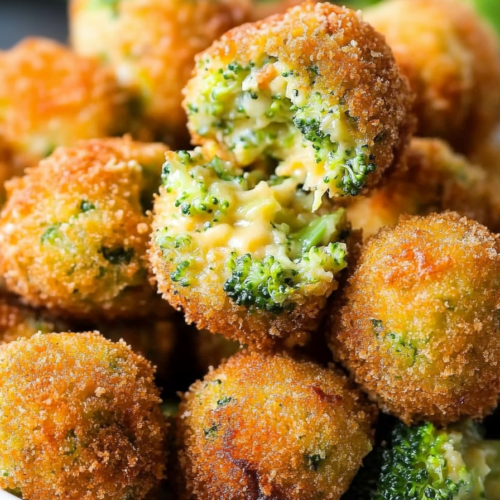 Golden-brown broccoli and cheese bites with a crunchy breaded coating, served in a bowl.