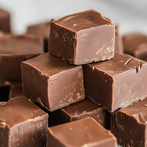 Close-up of rich, dense fudge pieces showing smooth tops and textured sides