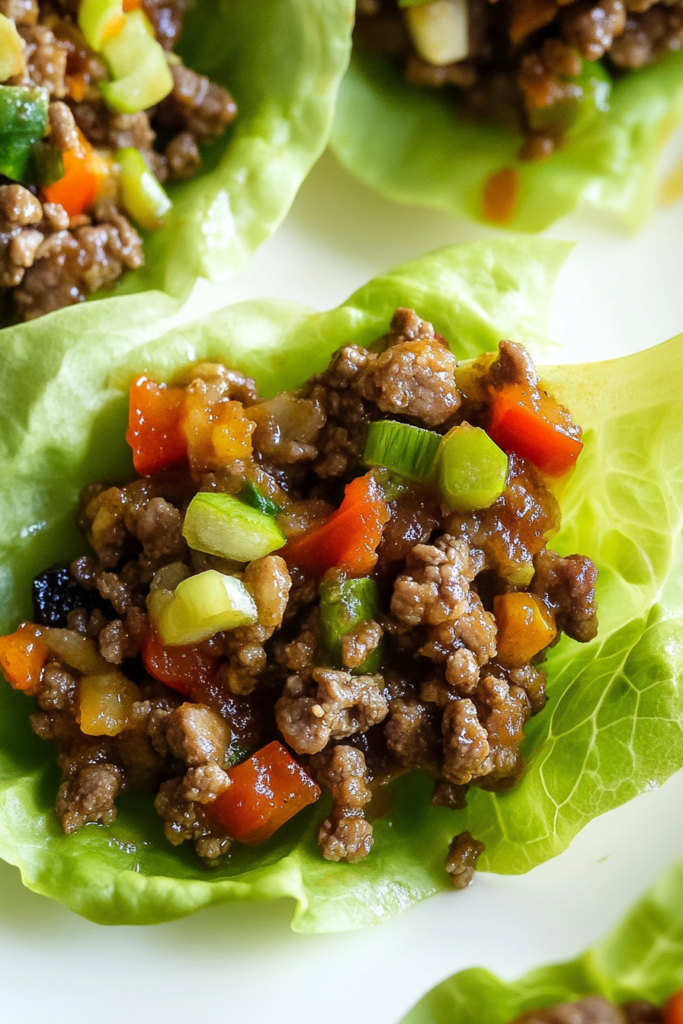 Ground beef and vegetable filling served in crisp lettuce cups.