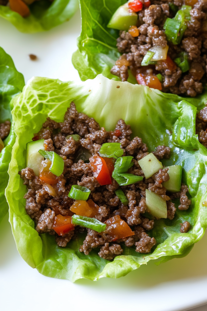 Healthy lettuce wraps topped with saucy ground beef and peppers.