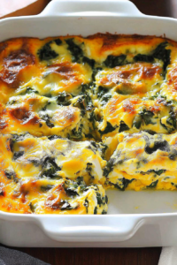 Golden baked casserole with spinach and eggs served straight from the baking dish