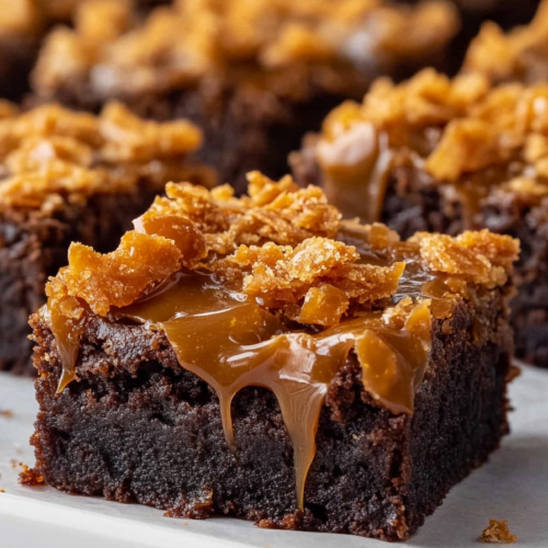 Double chocolate brownie square with caramel glaze and crunchy flakes.