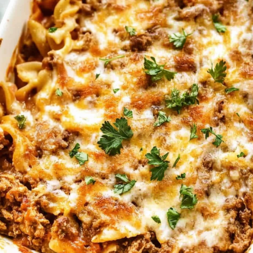 Hearty casserole slice showing beef, vegetables, and a golden melted cheese layer