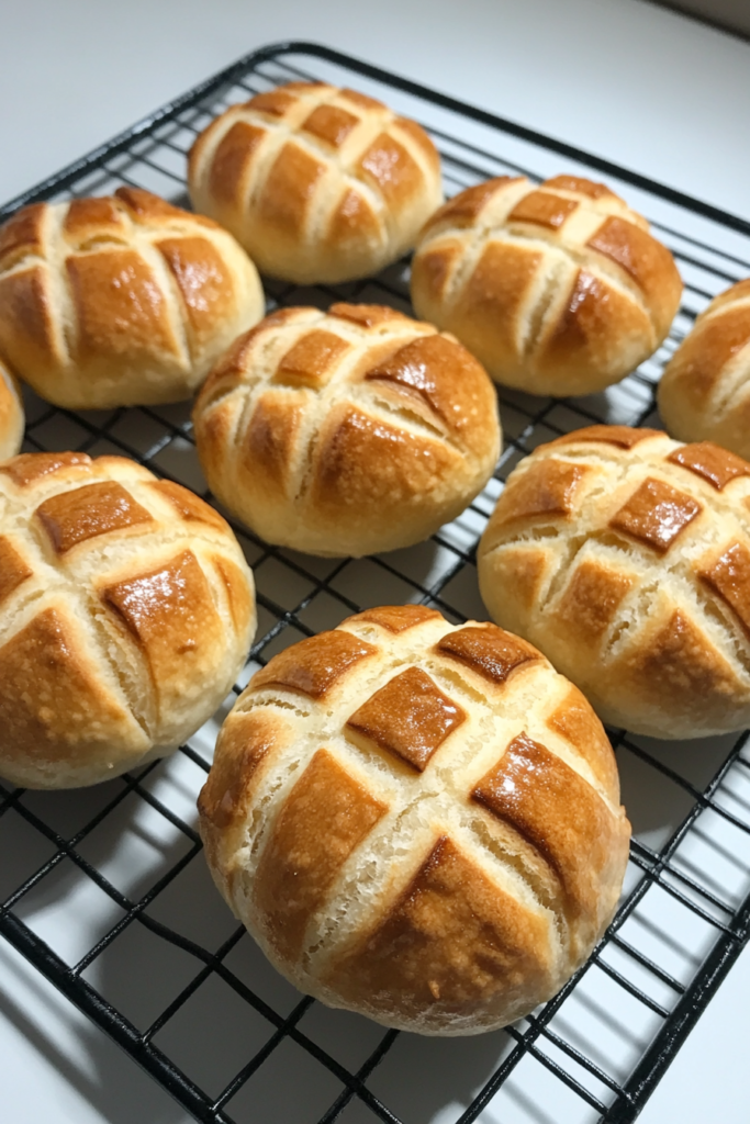 Close-up of golden bread buns with a signature patterned crust