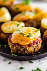 Comfort food meatloaf with tender potatoes and a rich, cheesy top.