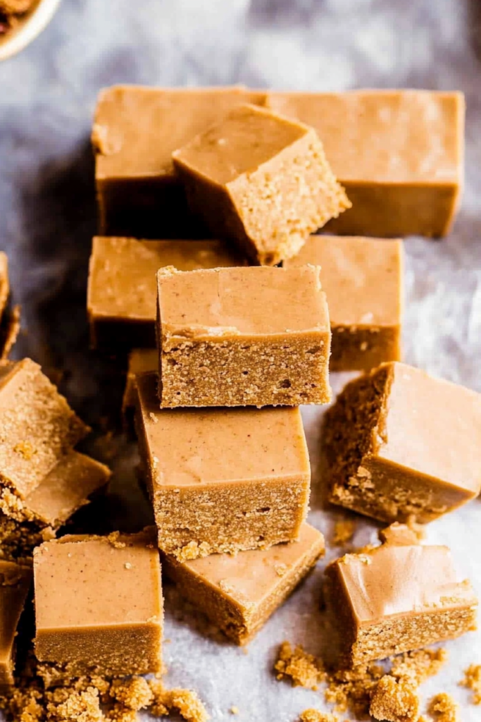 Serving of homemade fudge squares showing glossy tops and slightly rough edges