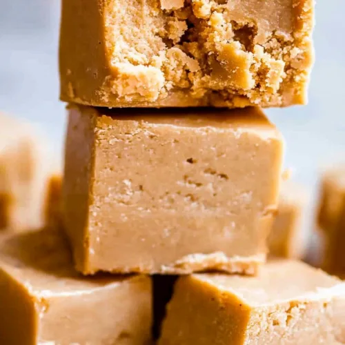 Close-up of rich, caramel-colored fudge pieces highlighting their dense and creamy consistency