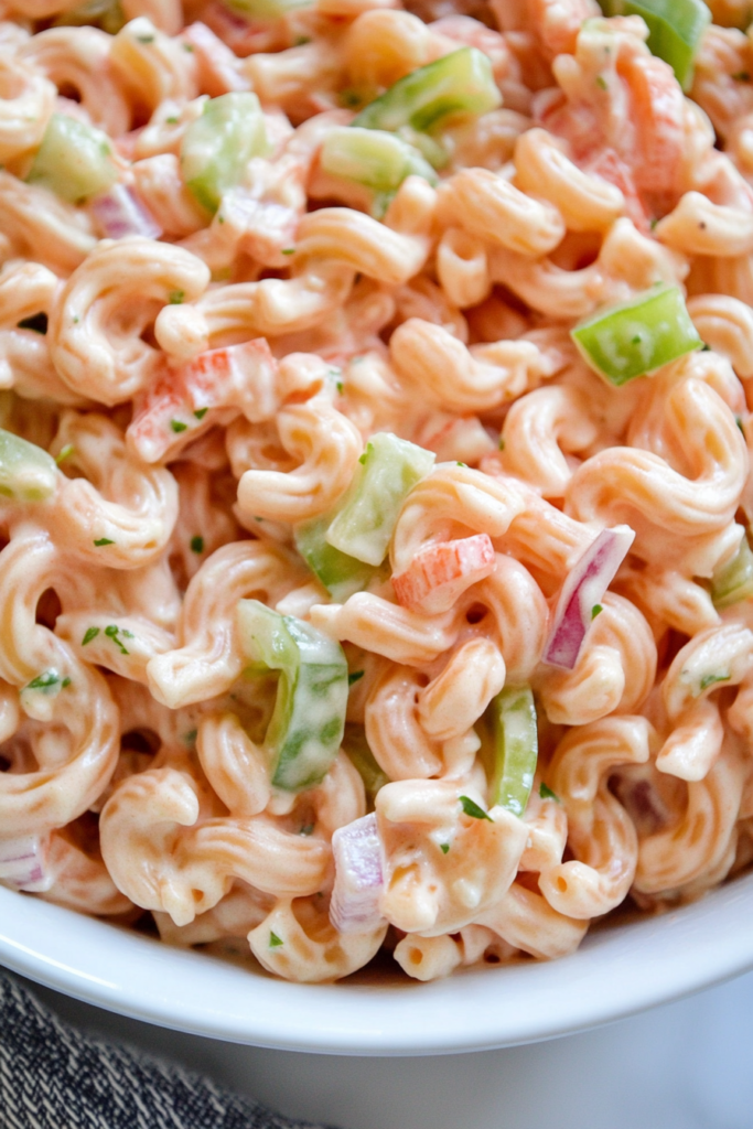 Pink Cadillac pasta salad served cold with bell peppers and onions mixed throughout.