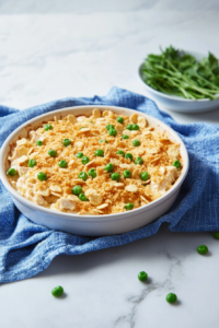 Warm casserole with a flaky cracker crust and creamy chicken visible underneath.