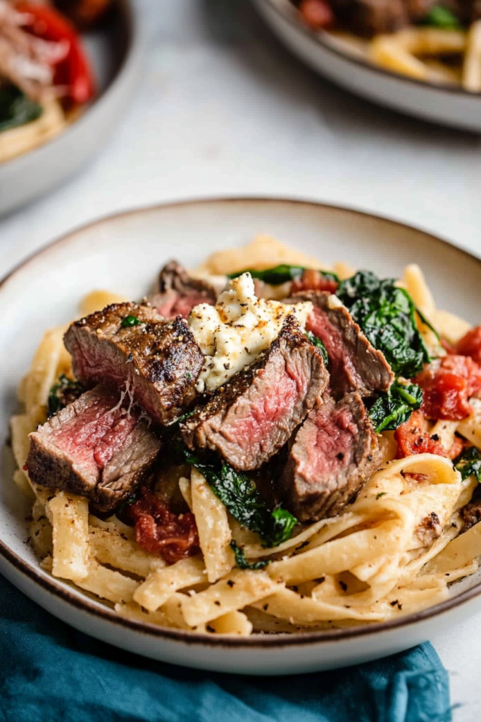 Creamy linguine paired with juicy steak pieces and spinach.