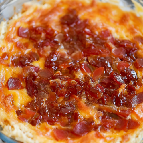 Close-up of melted cheddar and cream cheese covered in sweet and spicy jelly.