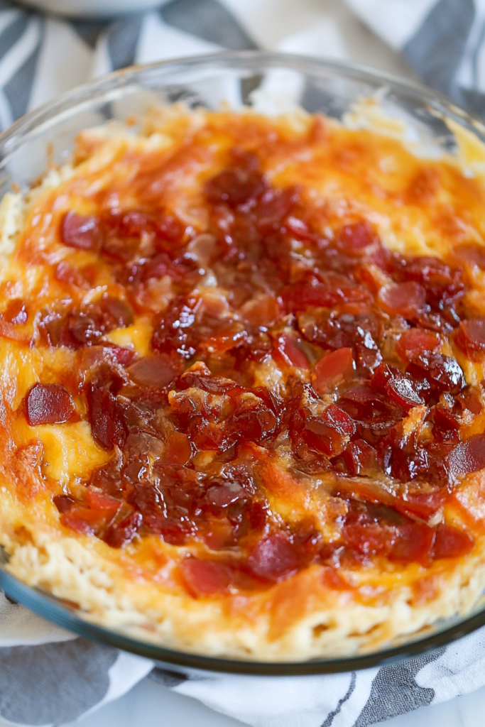 Close-up of melted cheddar and cream cheese covered in sweet and spicy jelly.