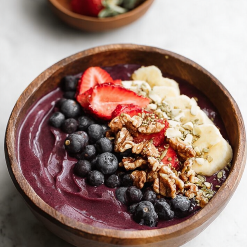 Thick blended fruit bowl finished with fresh berries and crunchy toppings.