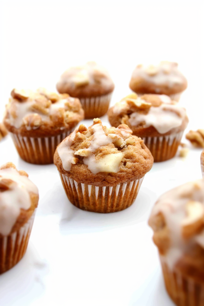 Freshly baked Apple Walnut Spice Muffins arranged on a plate, highlighting their rustic texture.