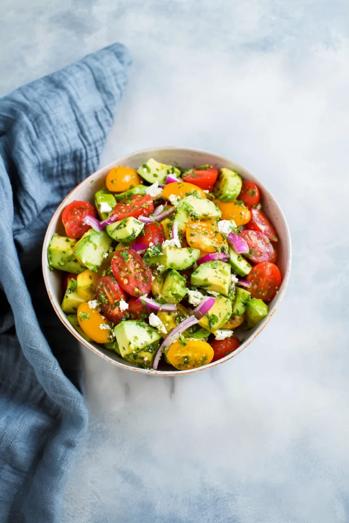 Bright summer side salad served chilled with simple olive oil and herb seasoning