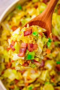 Close-up of sautéed cabbage tossed with smoky bacon and lightly caramelized edges