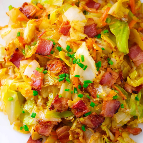 Tender cooked cabbage topped with crunchy bacon bits and parsley garnish