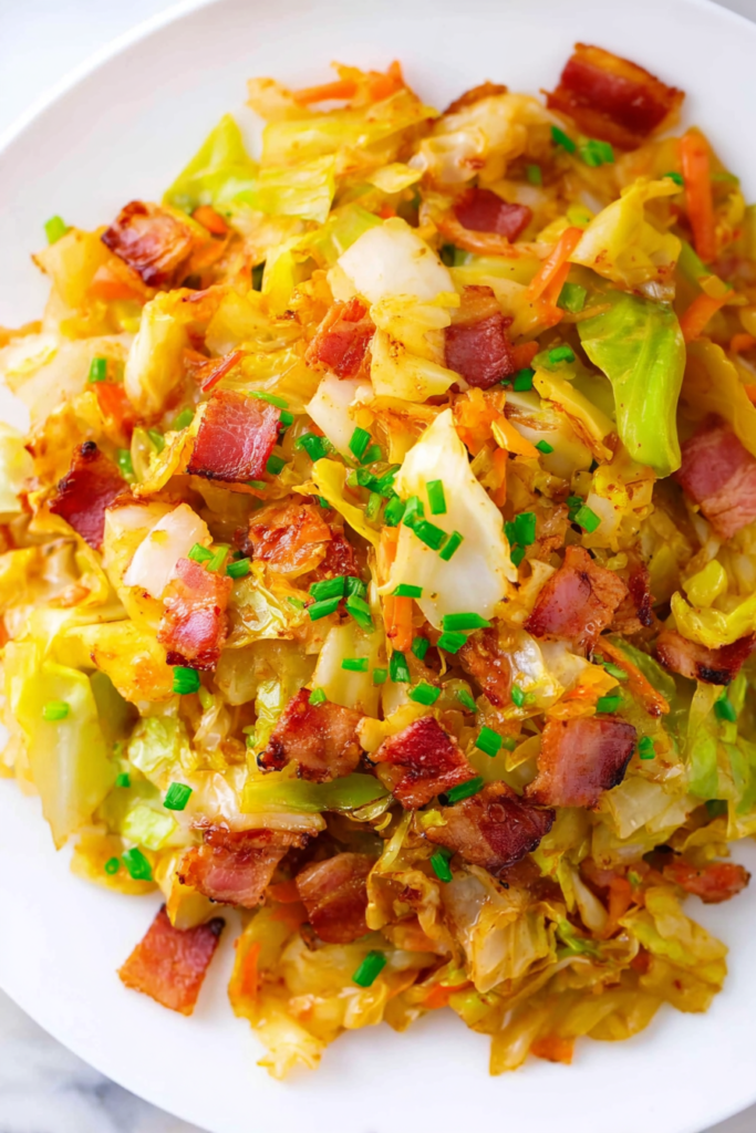 Tender cooked cabbage topped with crunchy bacon bits and parsley garnish